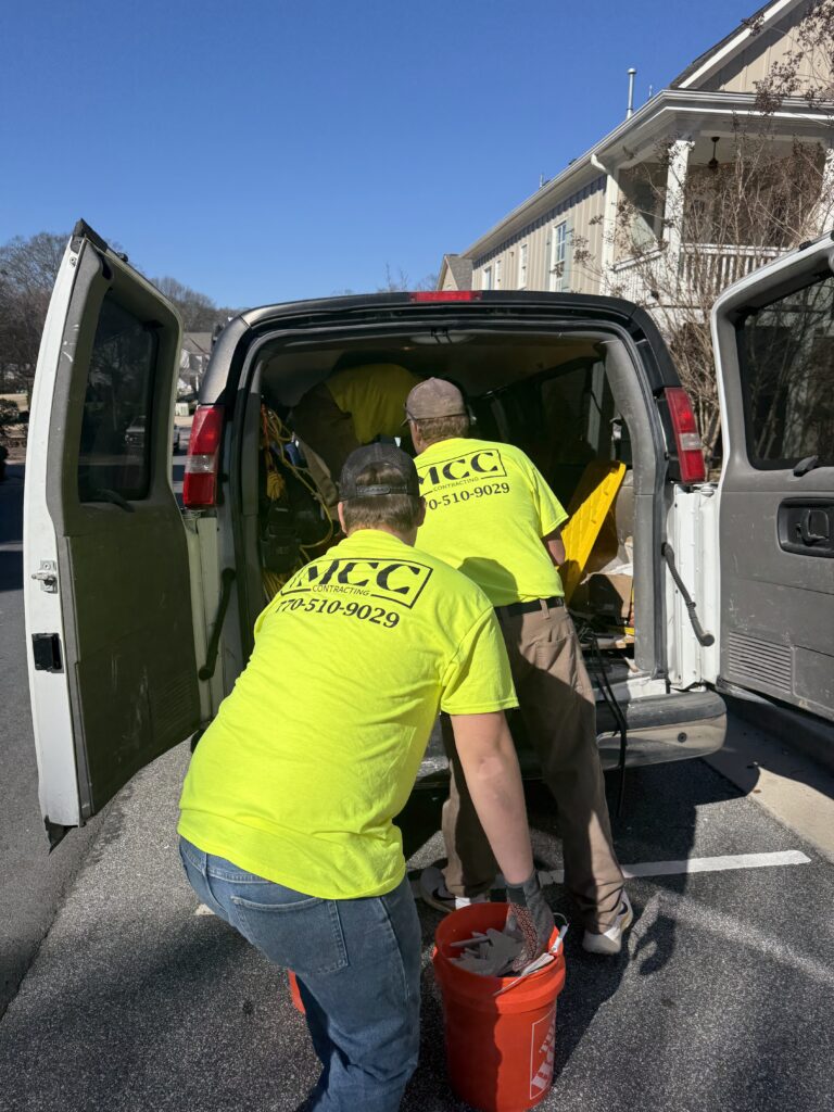 Workers unloading equipment from a van